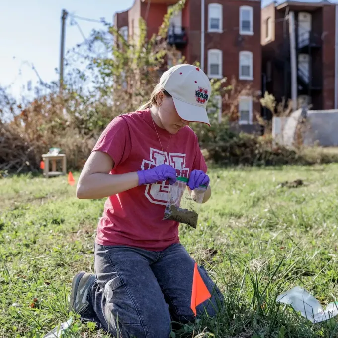 "Undergraduate EEPS major Charlie Rosser collects soil samples"