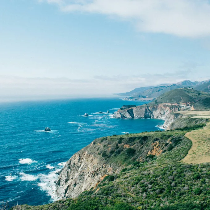 "Photo of Pacific Ocean with Rocky Coastline"