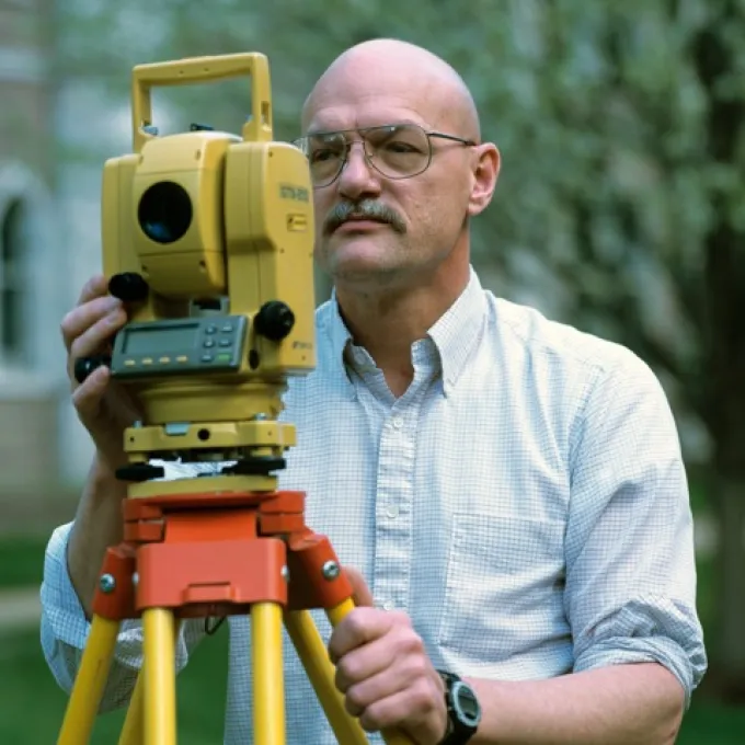 Bob Criss using survey equipment