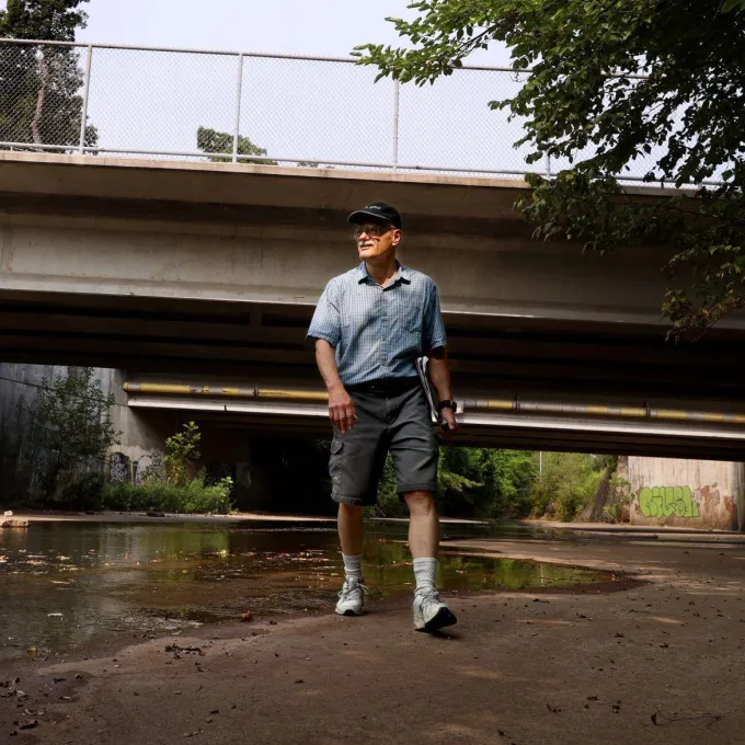 Bob Criss, a Washington University expert on urban creeks and rivers, steps along the paved basin of the River Des Peres on Wednesday, July 21, 2021, beneath Midland Boulevard at Wilson Avenue in University City. Photo by Christian Gooden.