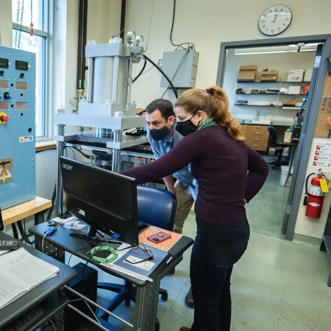 Phil Skemer (left) and research engineer Hélène Couvy Craigg working on a new large volume torsion apparatus (LVT) in the Rock Deformation Lab. The new equipment represents a significant upgrade for Skemer's lab. (Photo: Sean Garcia/Washington University)