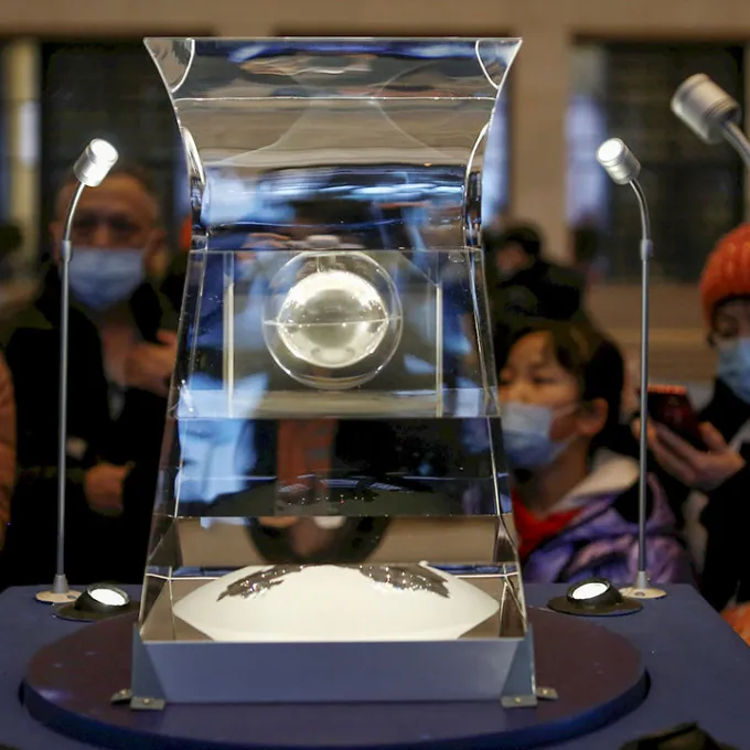 Visitors gawk at Chang’e-5 lunar samples on display at the National Museum of China in Beijing. Photo by Tingshu Wang/Reuters